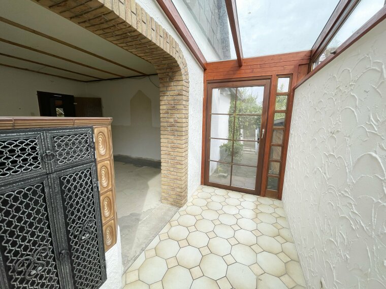 Wintergarten  mit Kachelofen